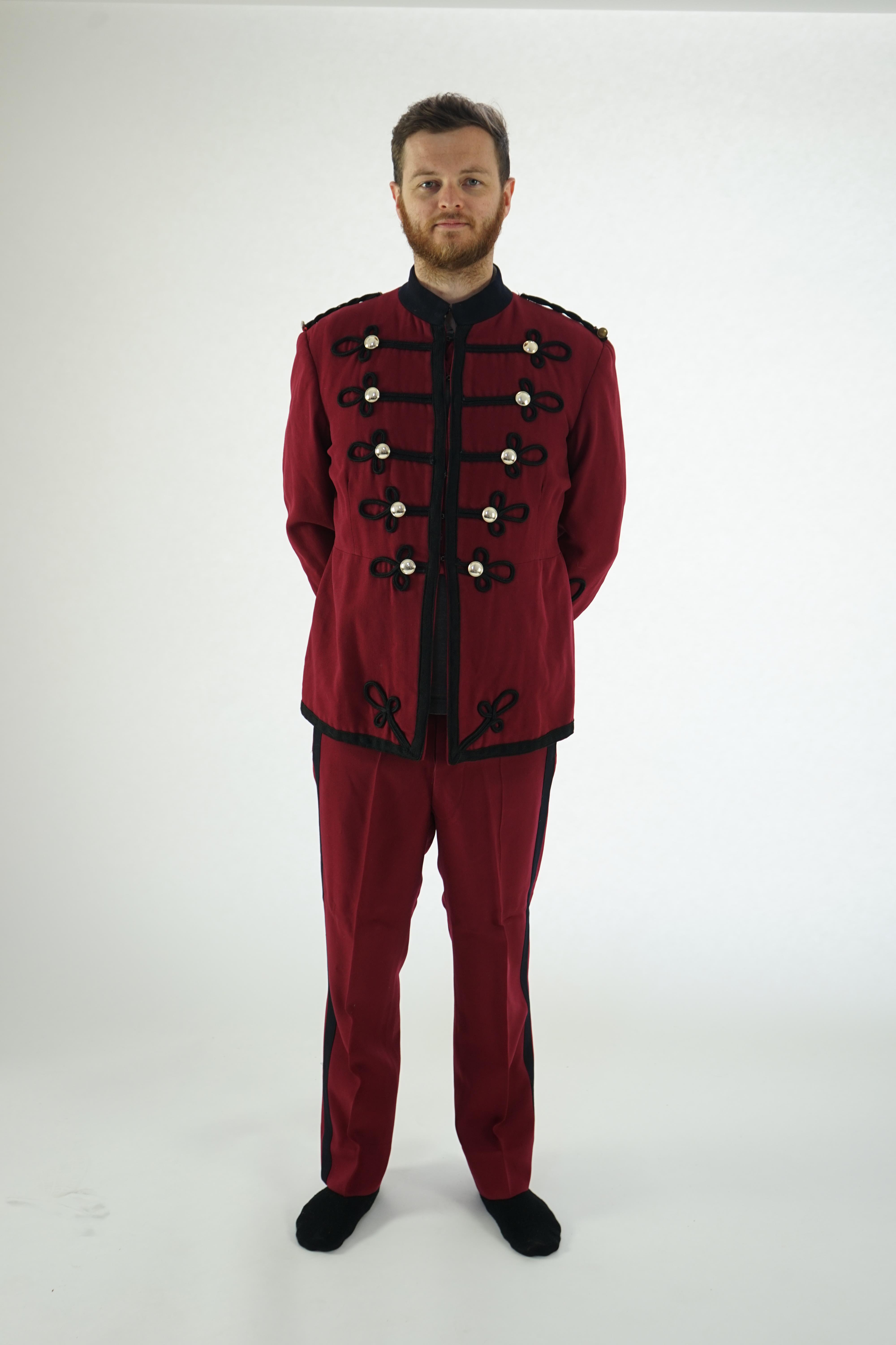 An early 20th century burgundy and black trim Military/Bandsman's uniform jacket and trousers.